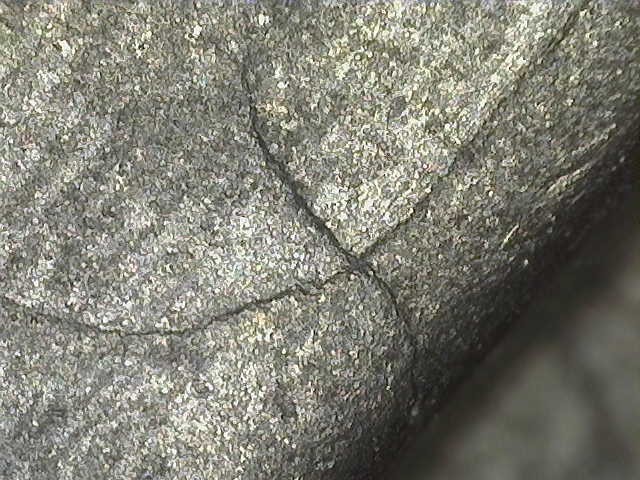 Microscopic crack in aircraft component after being cleaned out by wet blasting