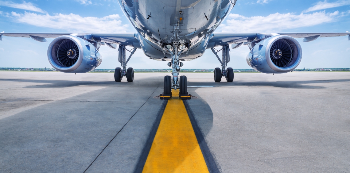 Underside of a passenger aircraft showing it's two jet engines