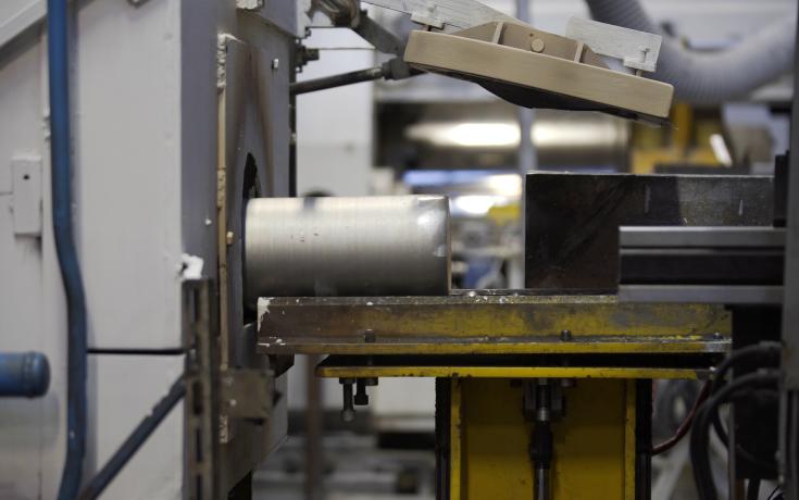 Extrusion billet going into an extrusion machine
