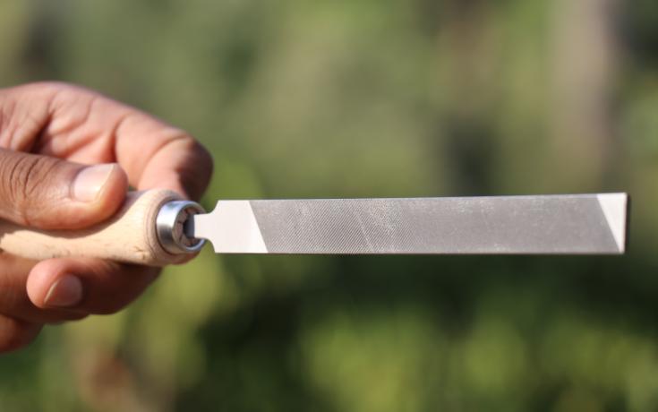 Flat steel file held in hand