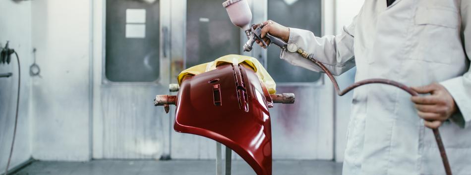 Spray painting a composite panel