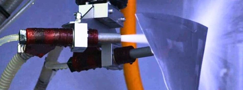 A jet engine fan blade being wet blasted