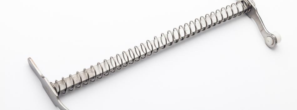 Surgical device with high performance spring