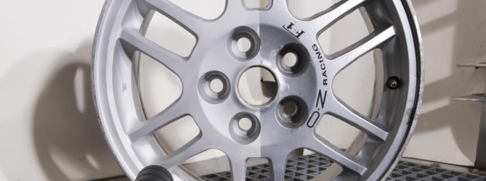 Alloy car wheel in a Vapormatt wet blasting cabinet with blast gun