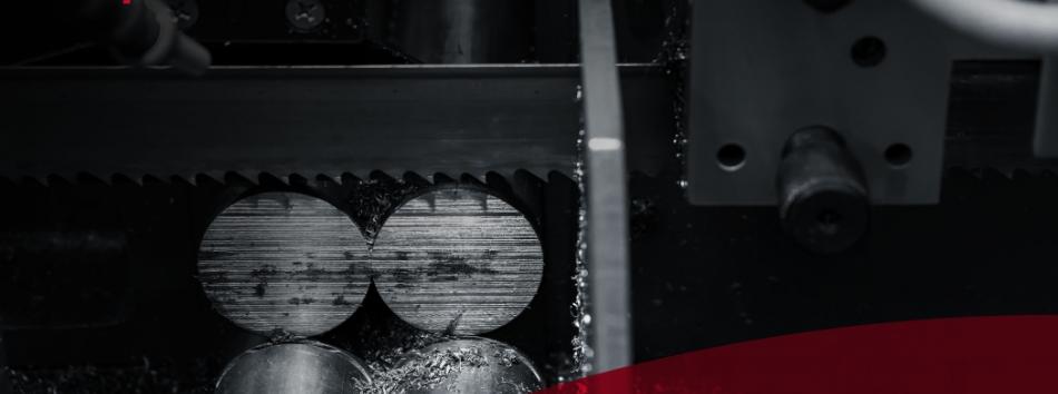 Image of wet-blasted bandsaw blades cutting through metal rods.