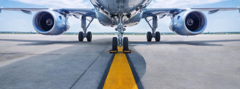 Underside of a passenger aircraft showing it's two jet engines