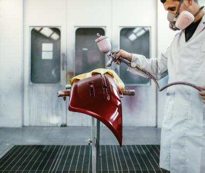 Spray painting a composite panel
