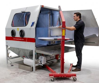 Vapormatt PumaXL manual wet blasting machine with an aircraft wheel being loaded on the turntable