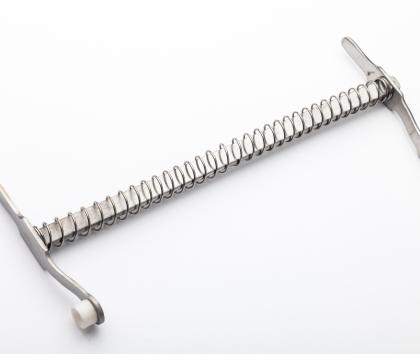 Surgical device with high performance spring