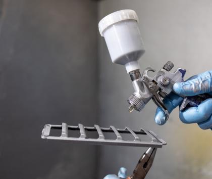 Additive manufactured component about to be spray painted