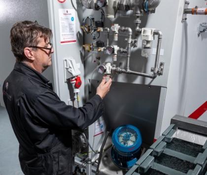 Vapormatt engineer maintaining a Vapormatt Cougar + automatic wet blasting machine