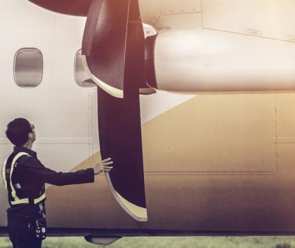 Person inspecting a composite propeller