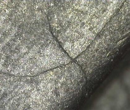 Microscopic crack in aircraft component after being cleaned out by wet blasting