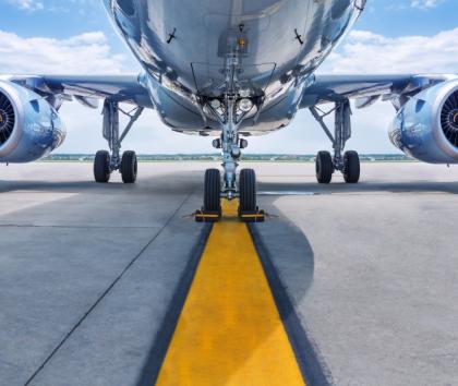 Underside of a passenger aircraft showing it's two jet engines