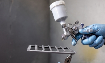 Additive manufactured component about to be spray painted