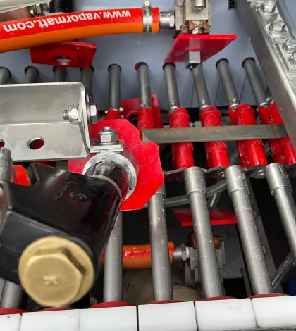 Vapormatt Profelis FR automatic wet blasting machine interior view of machine showing a hardened file with heat scale on the machine's conveyor before wet blasting