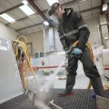 Blasting a component on a Leopard Sump wet blasting machine