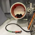 Vapormatt Puma+ automatic wet blasting machine fitted with a barrel for processing smaller components including additive manufactured components