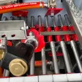 Vapormatt Profelis FR automatic wet blasting machine interior view of machine showing a hardened file with heat scale on the machine's conveyor before wet blasting