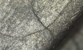 Microscopic crack in aircraft component after being cleaned out by wet blasting