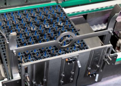 Cutting tool inserts in a tray in a Vapormatt Tiger automatic wet blasting machine