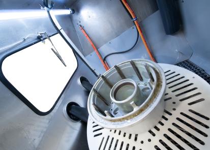Aircraft wheel inside a Vapormatt Puma XL manual wet blasting machine